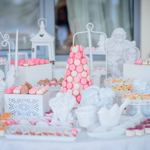 Beautiful candy bar of pink and white sweets decorated with figu