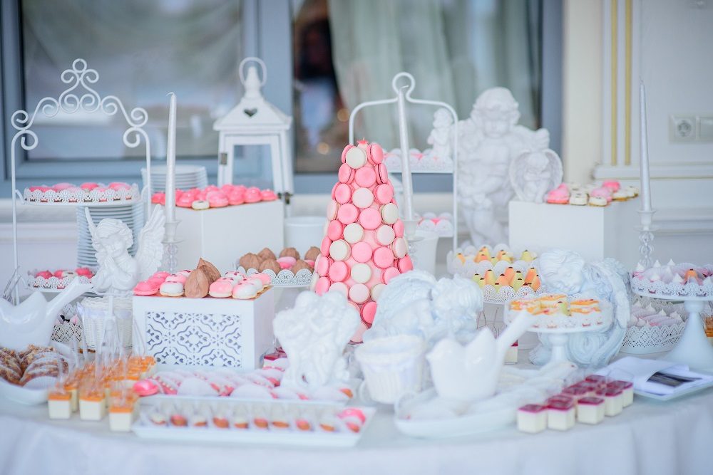 Beautiful candy bar of pink and white sweets decorated with figu